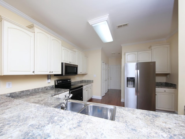 kitchen with a sink, dark wood-type flooring, visible vents, ornamental molding, and appliances with stainless steel finishes