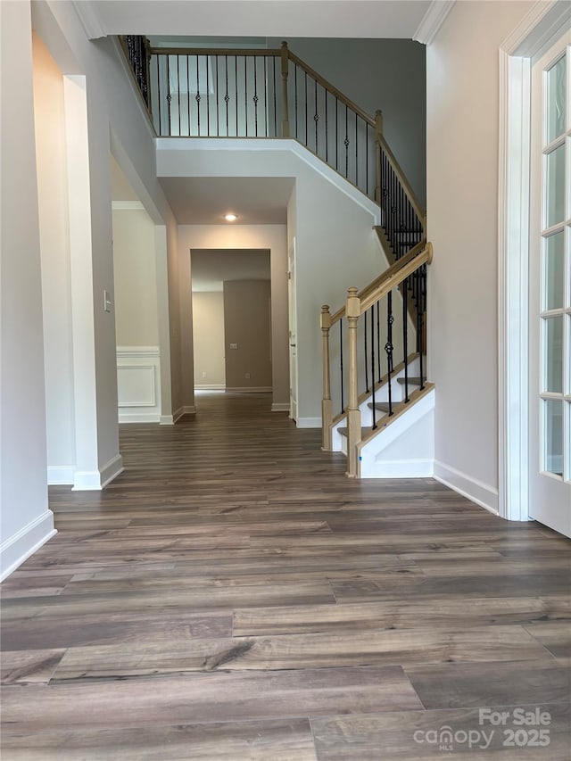 7001 New Town Rd, Waxhaw, NC 28173 - foyer entrance with wood finished floors, stairway, baseboards, and a high ceiling