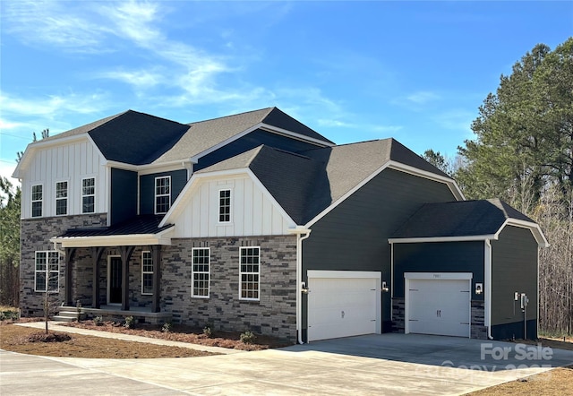 7001 New Town Rd, Waxhaw, NC 28173 - view of front of property featuring board and batten siding, driveway, a garage, and covered porch