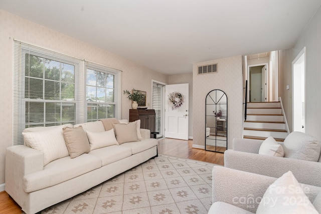 5329 Glenbrier Dr, Charlotte, NC 28212 - living room with light wood-type flooring, wallpapered walls, baseboards, attic access, and stairway