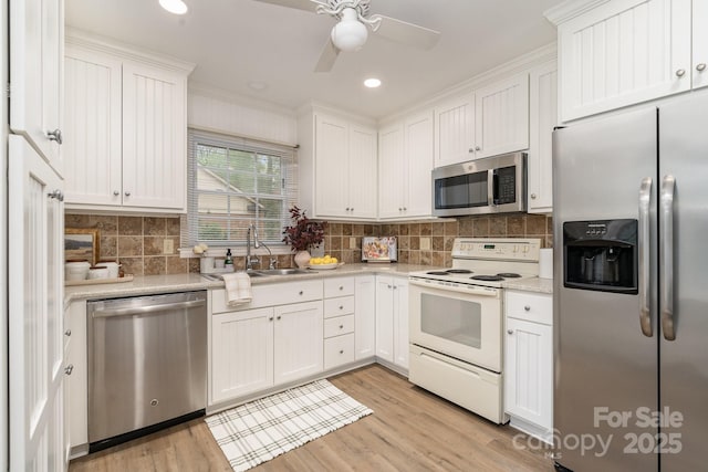 5329 Glenbrier Dr, Charlotte, NC 28212 - kitchen with stainless steel appliances, light countertops, white cabinets, ceiling fan, and light wood-style flooring
