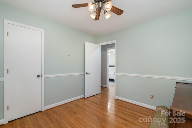 5329 Glenbrier Dr, Charlotte, NC 28212 - unfurnished bedroom with wood-type flooring, baseboards, and a ceiling fan
