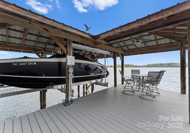 view of dock featuring boat lift and a water view