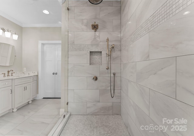 full bathroom with ornamental molding, marble finish floor, tiled shower, and vanity