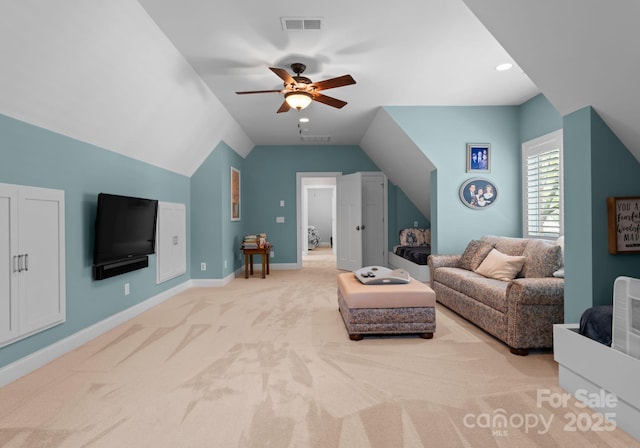 carpeted living area with lofted ceiling, ceiling fan, visible vents, and baseboards