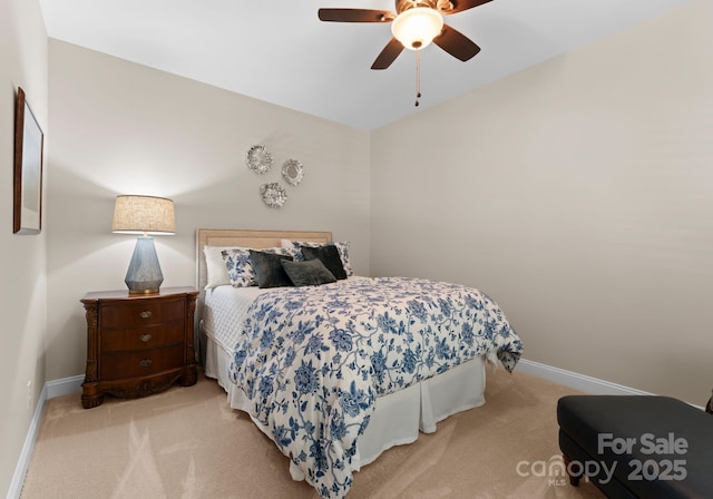 carpeted bedroom with ceiling fan and baseboards