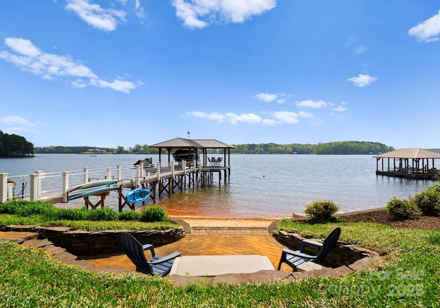 view of dock with a water view and a gazebo