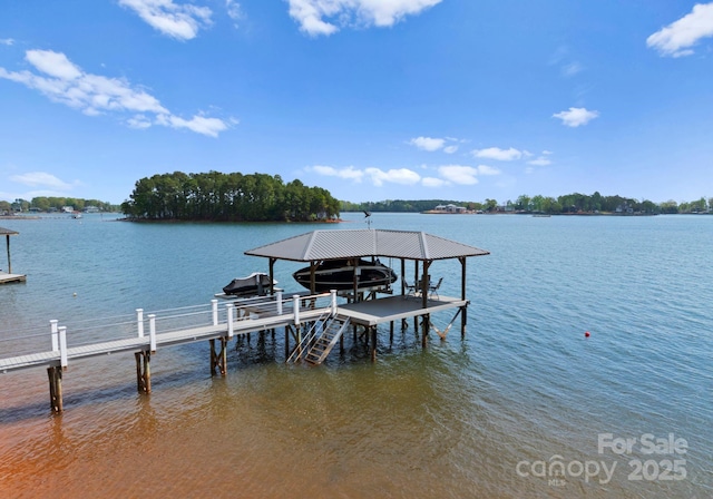 dock area with boat lift and a water view