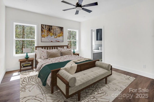 676 Chapel Hill Dr, Troy, NC 27371 - bedroom with multiple windows, baseboards, wood finished floors, and ensuite bath