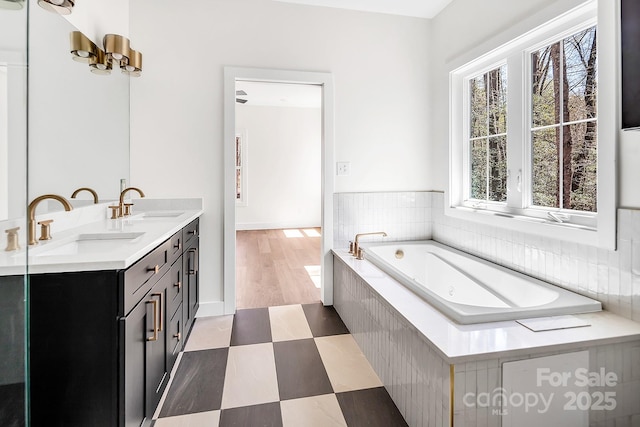 676 Chapel Hill Dr, Troy, NC 27371 - bathroom with a bath, double vanity, tile patterned floors, and baseboards
