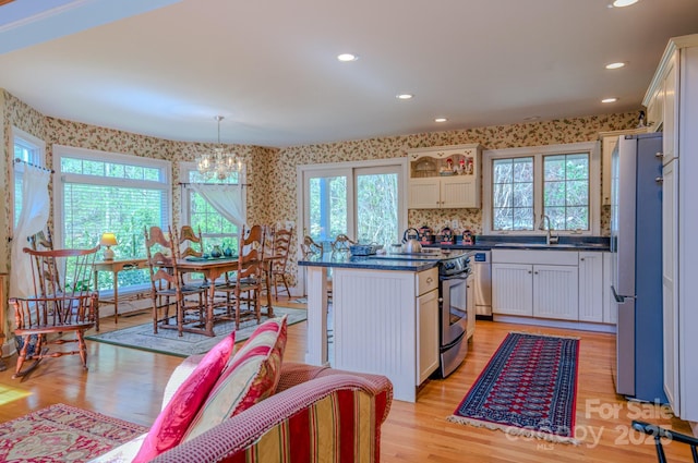 161 Hamburg Mountain Rd, Weaverville, NC 28787 - kitchen featuring appliances with stainless steel finishes, wallpapered walls, plenty of natural light, white cabinetry, and recessed lighting