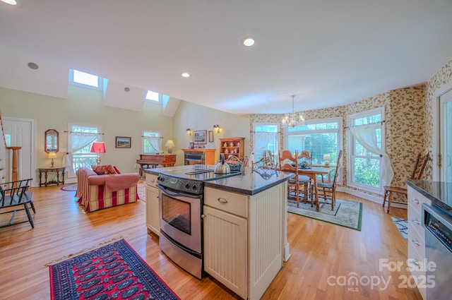 161 Hamburg Mountain Rd, Weaverville, NC 28787 - kitchen with appliances with stainless steel finishes, dark countertops, a chandelier, light wood-style flooring, and open floor plan