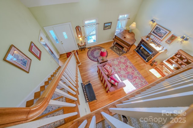 161 Hamburg Mountain Rd, Weaverville, NC 28787 - staircase with wood finished floors, a fireplace, and baseboards