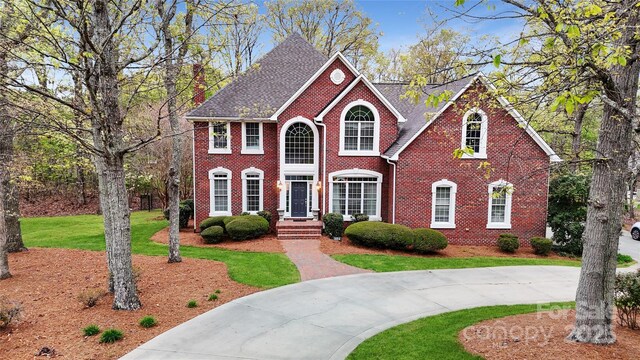 101 Saddletree Rd, Lincolnton, NC 28092 - view of front facade with a front lawn, brick siding, and curved driveway