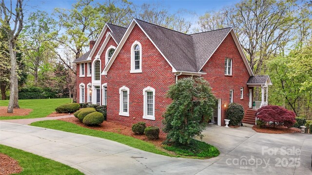 101 Saddletree Rd, Lincolnton, NC 28092 - view of front of property with brick siding, driveway, a shingled roof, and a front yard