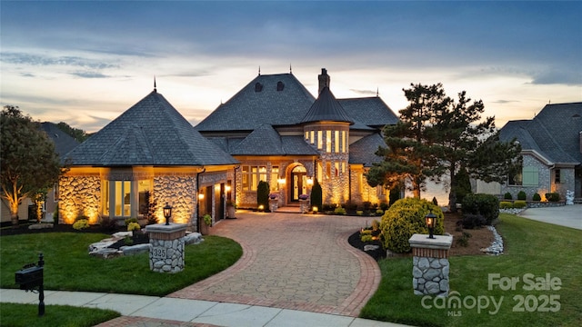325 Ivy Arbor Cir, Rock Hill, SC 29732 - french provincial home featuring an attached garage, a chimney, curved driveway, a front lawn, and stone siding