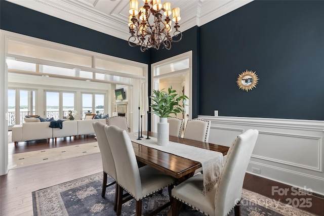 325 Ivy Arbor Cir, Rock Hill, SC 29732 - dining space with a chandelier, ornamental molding, a wainscoted wall, and wood finished floors