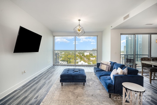 333 W Trade St Unit 1802, Charlotte, NC 28202 - living area featuring visible vents, baseboards, a healthy amount of sunlight, and wood finished floors