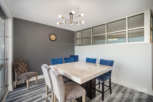 333 W Trade St Unit 1802, Charlotte, NC 28202 - dining room with baseboards, wood finished floors, and a chandelier