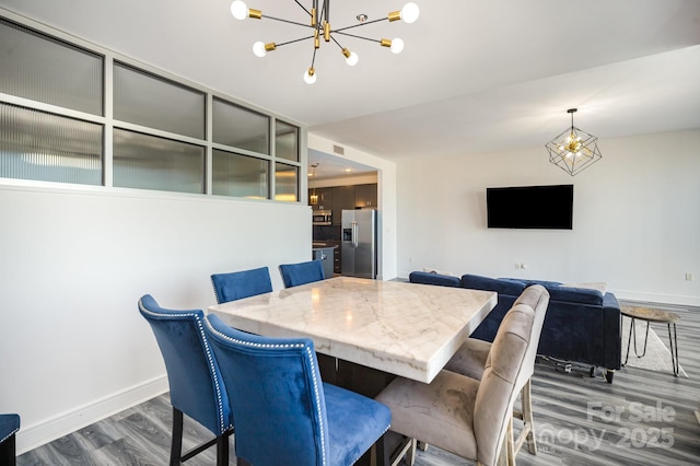333 W Trade St Unit 1802, Charlotte, NC 28202 - dining space featuring baseboards, a chandelier, and wood finished floors