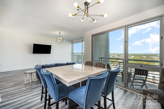 333 W Trade St Unit 1802, Charlotte, NC 28202 - dining area featuring baseboards, wood finished floors, and a chandelier