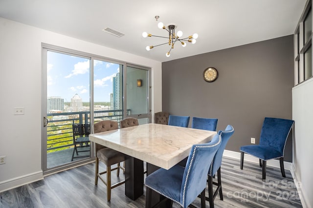 333 W Trade St Unit 1802, Charlotte, NC 28202 - dining area with baseboards, visible vents, a view of city, and a chandelier