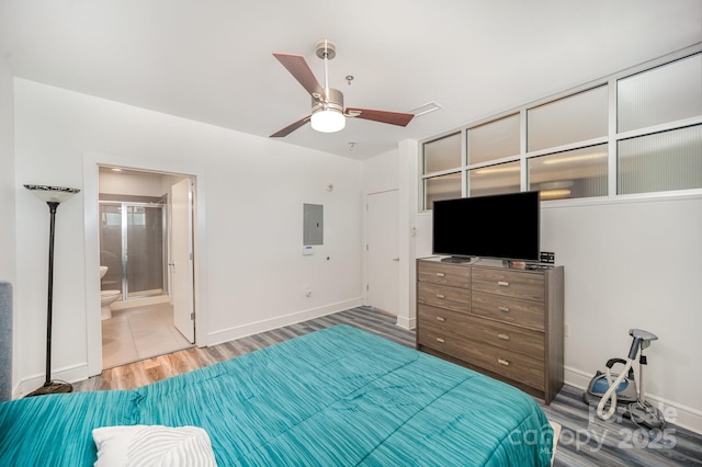 333 W Trade St Unit 1802, Charlotte, NC 28202 - unfurnished bedroom with electric panel, baseboards, wood finished floors, and ceiling fan
