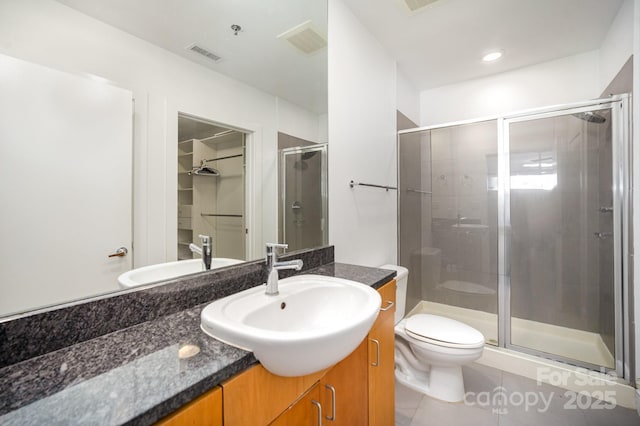 333 W Trade St Unit 1802, Charlotte, NC 28202 - bathroom with toilet, vanity, a stall shower, and visible vents