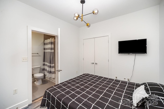 333 W Trade St Unit 1802, Charlotte, NC 28202 - bedroom featuring a closet, wood finished floors, and a chandelier