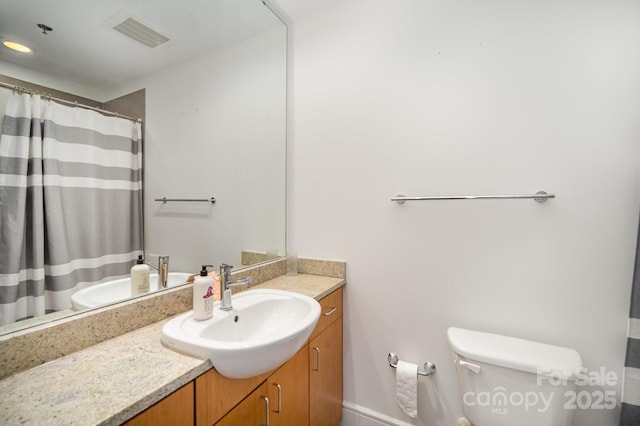 333 W Trade St Unit 1802, Charlotte, NC 28202 - full bath with visible vents, curtained shower, toilet, and vanity