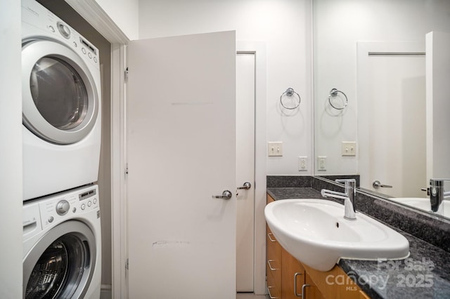 333 W Trade St Unit 1802, Charlotte, NC 28202 - clothes washing area with stacked washer and dryer, a sink, and laundry area