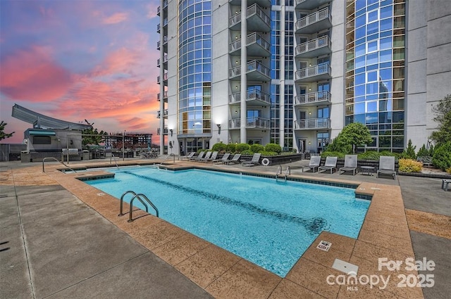 333 W Trade St Unit 1802, Charlotte, NC 28202 - pool at dusk with a patio and a community pool