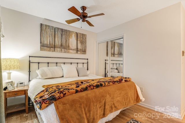 bedroom featuring baseboards, ceiling fan, and wood finished floors
