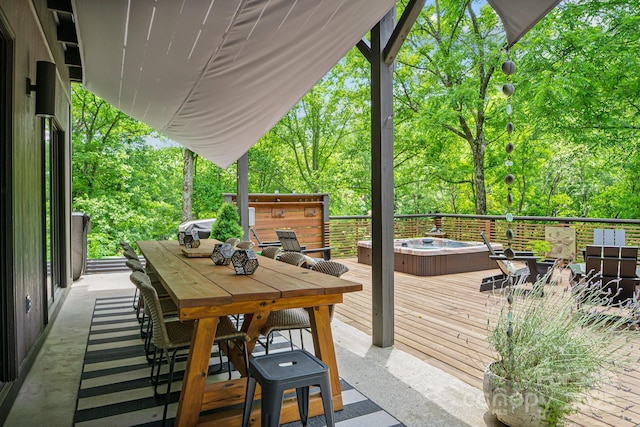 wooden terrace with outdoor dining space and hot tub deck surround