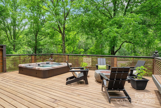 wooden terrace with a fire pit and hot tub deck surround