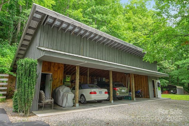 view of car parking with a wooded view