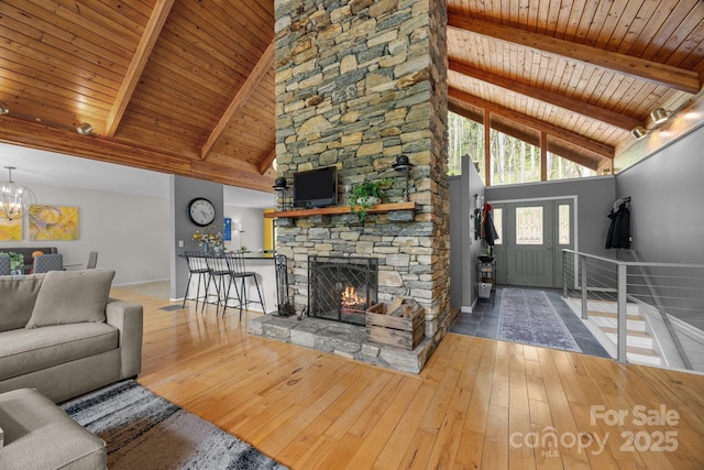 living area featuring wood-type flooring, high vaulted ceiling, and wooden ceiling
