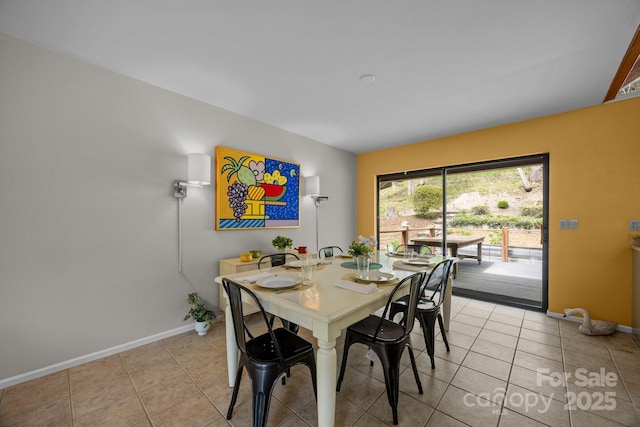 dining area with baseboards and light tile patterned floors
