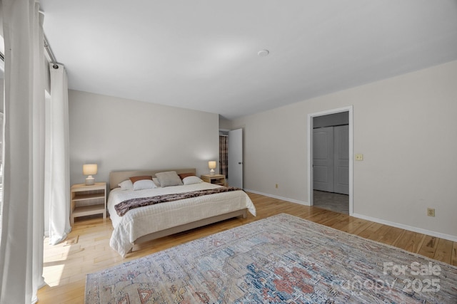 bedroom with baseboards and light wood-style floors