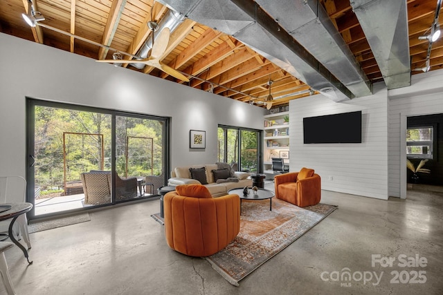 living area featuring concrete flooring and a healthy amount of sunlight