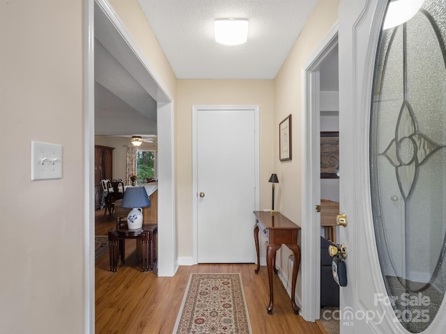 2248 Lawton Bluff Rd, Charlotte, NC 28226 - foyer featuring light wood-type flooring, a textured ceiling, and ceiling fan