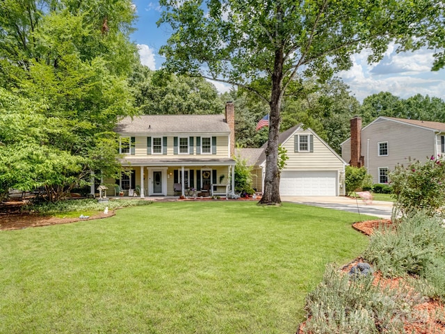 2248 Lawton Bluff Rd, Charlotte, NC 28226 - colonial-style house with covered porch, a chimney, a garage, a front lawn, and concrete driveway