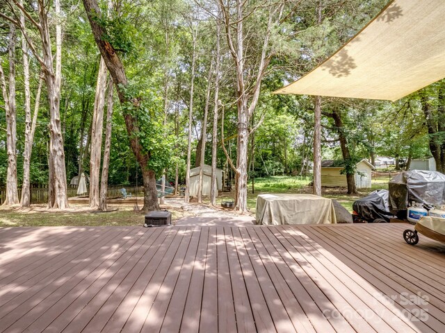 2248 Lawton Bluff Rd, Charlotte, NC 28226 - wooden deck with a storage unit and view of scattered trees