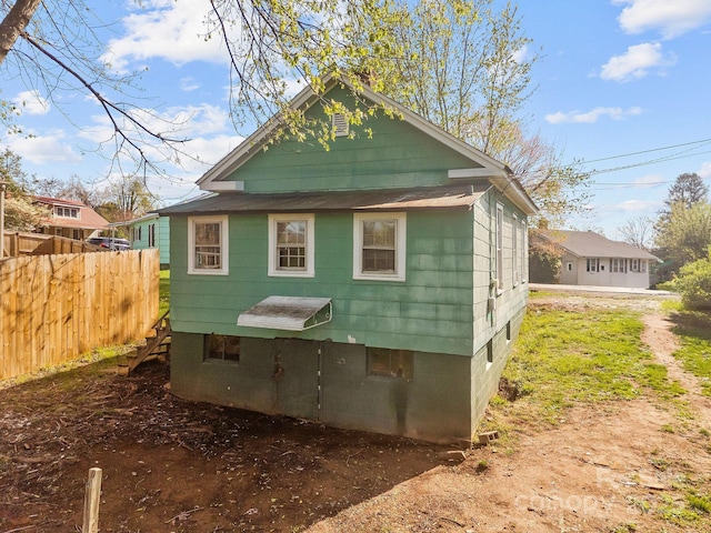 view of side of property featuring fence