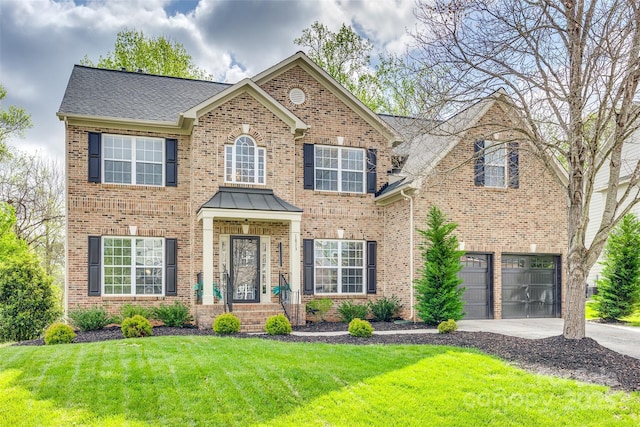 view of front of property featuring brick siding, an attached garage, driveway, and a front lawn