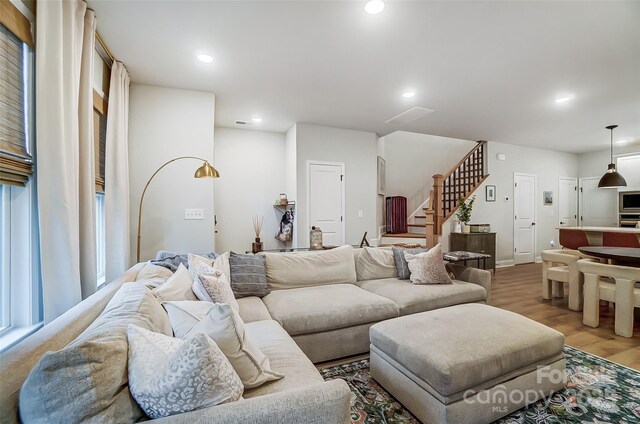 living room with stairs, wood finished floors, and recessed lighting