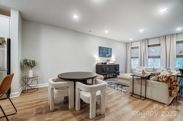 dining space featuring light wood-style flooring, baseboards, and recessed lighting