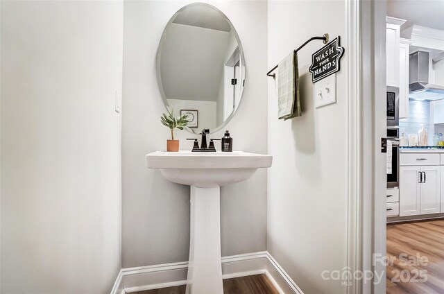 bathroom featuring baseboards and wood finished floors