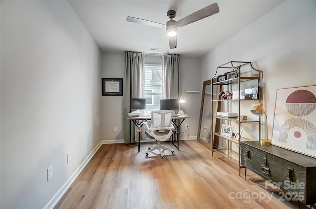 office space with a ceiling fan, baseboards, and wood finished floors