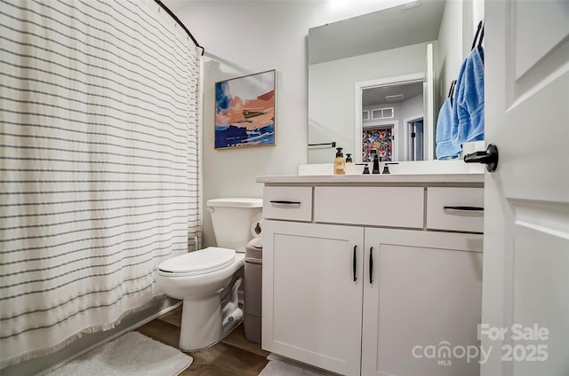 full bathroom featuring toilet, vanity, and wood finished floors